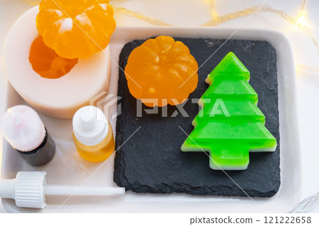 Handmade soap in the form of Orange tangerine And a green Christmas tree with bottles of dye, flavor, a block of glycerin soap base, silicone mold, pipette. Soap as a gift, home-made Handmade soap in the form of Orange tangerine And a green Christmas tree with bottles of dye, flavor, a block of glycerin soap base, silicone mold, pipette. Soap as a gift, home-made 121222658