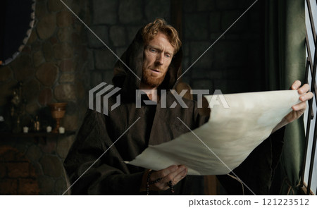 Medieval monk reading obsolete historical parchments and holy manuscripts Medieval monk reading obsolete historical parchments and holy manuscripts 121223512