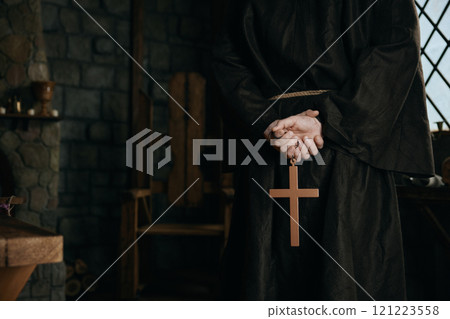 Closeup view cropped shot with golden cross in priest monk hands Closeup view cropped shot with golden cross in priest monk hands 121223558