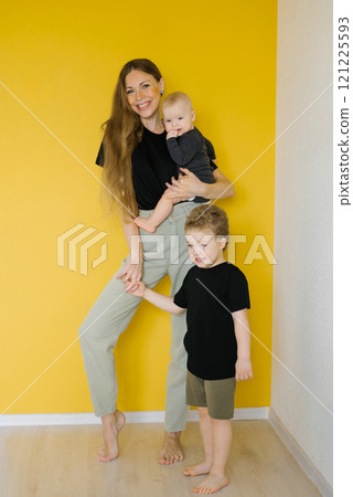 Happy mom with two small children at home 121225593