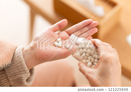 Middle-aged to senior women taking pills Middle-aged to senior women taking pills 121225939