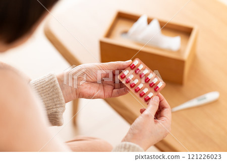 Middle-aged to senior women holding capsule medicine Middle-aged to senior women holding capsule medicine 121226023