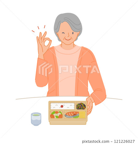 A smiling senior woman (living alone) making a circle pose with her hands on her lunch box A smiling senior woman (living alone) making a circle pose with her hands on her lunch box 121226027