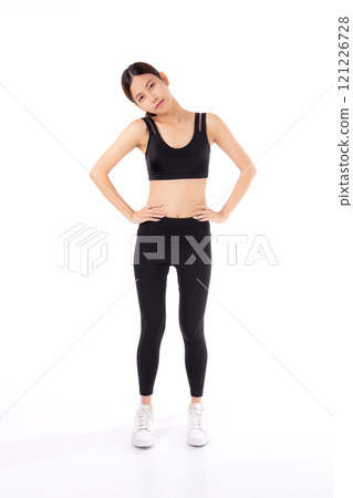 Portrait of beautiful young asian woman in sportwear smile and showing waist and abs isolated. Portrait of beautiful young asian woman in sportwear smile and showing waist and abs isolated. 121226728