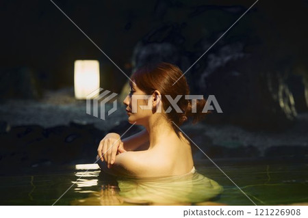 A young woman bathing in an open-air bath. Photo courtesy of Shiratama no Yu Izumi Kei 121226908