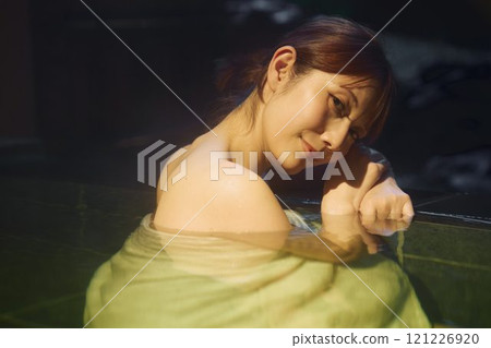 A young woman bathing in an open-air bath. Photo courtesy of Shiratama no Yu Izumi Kei A young woman bathing in an open-air bath. Photo courtesy of Shiratama no Yu Izumi Kei 121226920