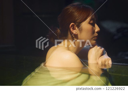 A young woman bathing in an open-air bath. Photo courtesy of Shiratama no Yu Izumi Kei 121226922