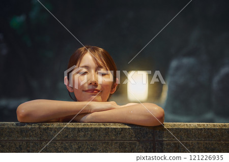 A young woman bathing in an open-air bath. Photo courtesy of Shiratama no Yu Izumi Kei 121226935