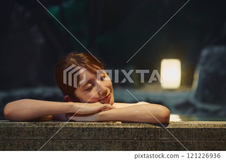 A young woman bathing in an open-air bath. Photo courtesy of Shiratama no Yu Izumi Kei A young woman bathing in an open-air bath. Photo courtesy of Shiratama no Yu Izumi Kei 121226936