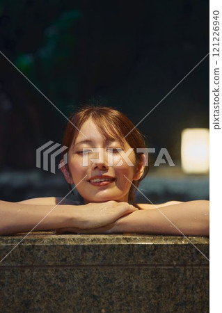 A young woman bathing in an open-air bath. Photo courtesy of Shiratama no Yu Izumi Kei 121226940