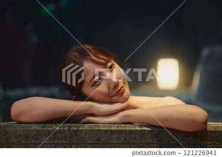 A young woman bathing in an open-air bath. Photo courtesy of Shiratama no Yu Izumi Kei A young woman bathing in an open-air bath. Photo courtesy of Shiratama no Yu Izumi Kei 121226941