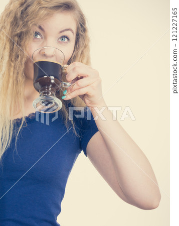 Positive woman drinking her morning coffee 121227165
