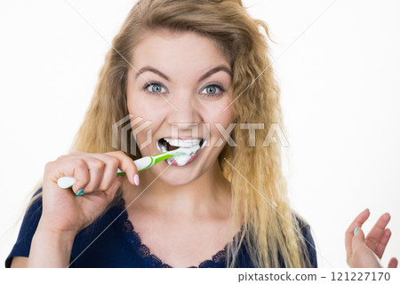 Woman brushing cleaning teeth Woman brushing cleaning teeth 121227170