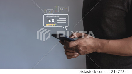 Review Excellence, Young Man hand using smartphone mobile with five star to review and give 5 stars 121227231