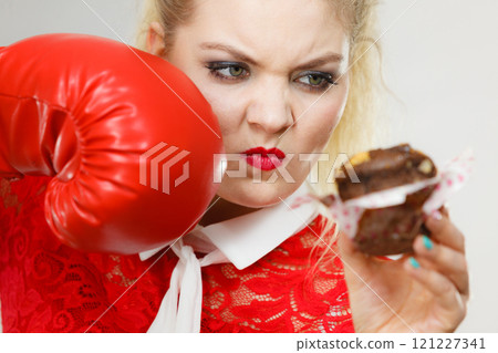 Woman boxing chocolate cupcake 121227341