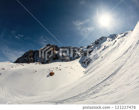 High altitude winter landscape of the mountain range with ski and snowboard path, Sunny winter day in the mountains. 121227478