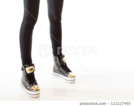 Teen fashion. Female legs in sneakers 121227493