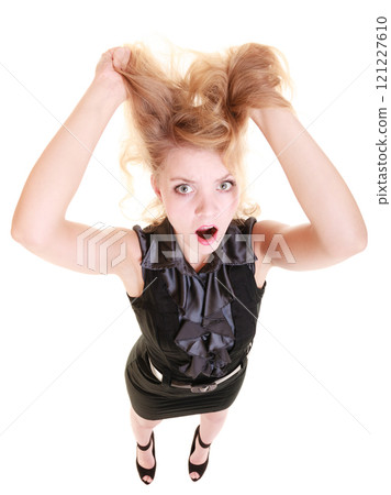 Angry furious woman screaming and pulling messy hair Angry furious woman screaming and pulling messy hair 121227610