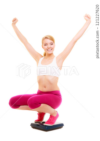 Glad woman weighing scale. Slimming weight loss. 121227620