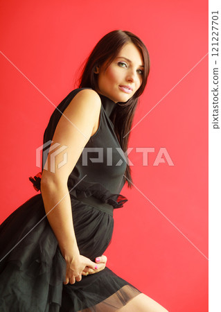 Stylish pregnant woman in black. Stylish pregnant woman in black. 121227701