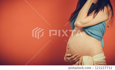 Closeup on tummy of pregnant woman. 121227712