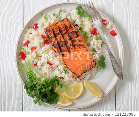 grilled red salmon fillet with rice, top view 121228096