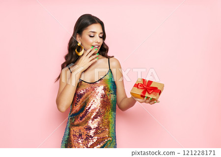 Beautiful woman in cocktail dress with gift boxes 121228171