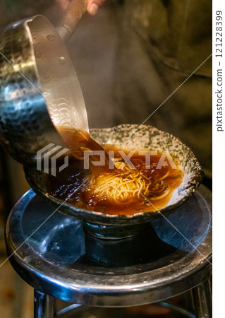 Cook preparing ramen meal 121228399