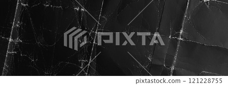 Wrinkled crumpled black paper with worn texture. Distressed folds on dark abstract cardboard background surface. Top view Wrinkled crumpled black paper with worn texture. Distressed folds on dark abstract cardboard background surface. Top view 121228755