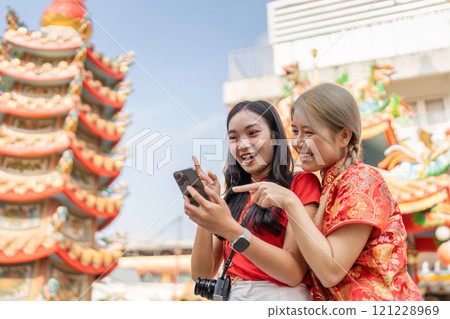 Celebrating chinese new year tourists enjoy festivities in vibrant cityscape with colorful decorations Celebrating chinese new year tourists enjoy festivities in vibrant cityscape with colorful decorations 121228969