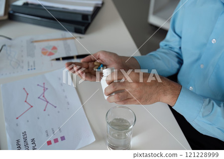 Taking medicine for feeling unwell a business professional's routine office environment health awareness 121228999