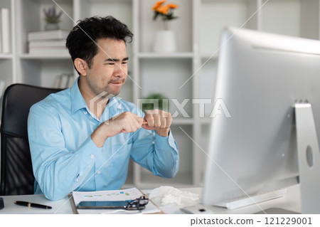 Tired employee demonstrates hard work at home office digital workspace stress and focus professional environment 121229001