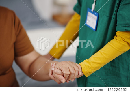 Nurse Supporting Old Woman During Rehabilitation 121229362