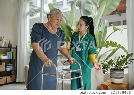 Young Caregiver Caring About Senior Woman 121229438