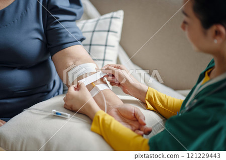 Nurse Making IV Drip To Patient Nurse Making IV Drip To Patient 121229443