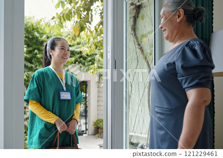 Senior Woman Meeting Her Caregiver 121229461