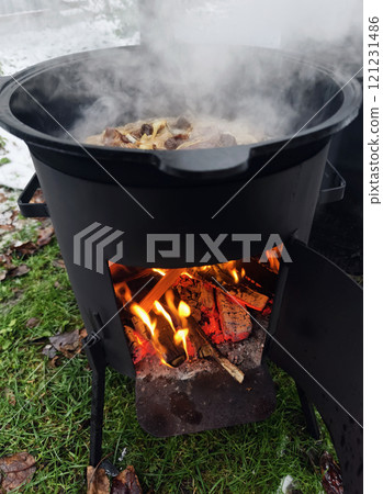 cooking pilaf in a cauldron on fire cooking pilaf in a cauldron on fire 121231486