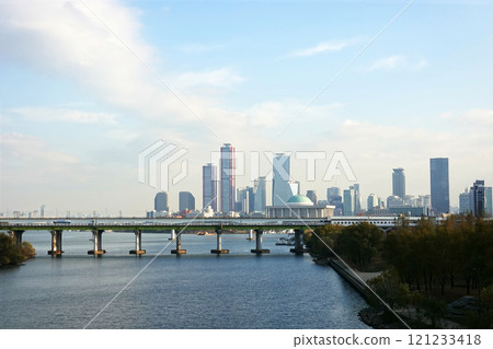A skyline of Yeouido, Seoul, Korea with modern skyscrapers and a bridge over a river. 121233418