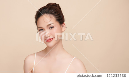 Beautiful young asian woman with clean fresh skin on beige background, Face care, Facial treatment, Cosmetology, beauty and spa, Asian women portrait. Beautiful young asian woman with clean fresh skin on beige background, Face care, Facial treatment, Cosmetology, beauty and spa, Asian women portrait. 121233588