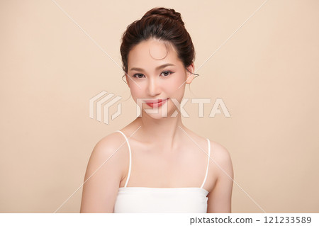 Beautiful young asian woman with clean fresh skin on beige background, Face care, Facial treatment, Cosmetology, beauty and spa, Asian women portrait. Beautiful young asian woman with clean fresh skin on beige background, Face care, Facial treatment, Cosmetology, beauty and spa, Asian women portrait. 121233589