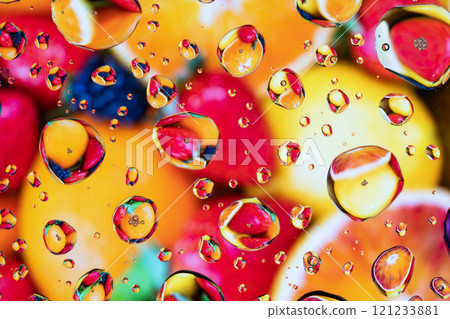 Splash of water drops on glass with colorful background. 121233881