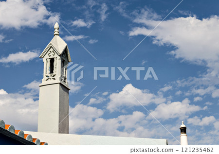 Typical ornate chimney of the Algarve, Portugal, on blue background 121235462