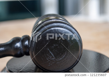 Close up of gavel next to prison. Law and regulation concept. 121235607
