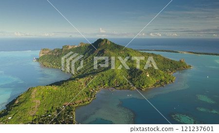 Aerial view of Maupiti, a volcanic island in French Polynesia, verdant slopes, turquoise lagoon, and coral reefs under clear sky. Wild travel destination, remote nature paradise, exotic summer travel Aerial view of Maupiti, a volcanic island in French Polynesia, verdant slopes, turquoise lagoon, and coral reefs under clear sky. Wild travel destination, remote nature paradise, exotic summer travel 121237601