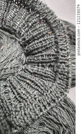 Knitted product from dark threads. Knitting a neck for a sweater with knitting needles. Knitted product from dark threads. Knitting a neck for a sweater with knitting needles. 121238074