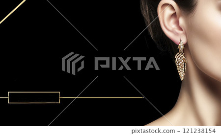 Close-up of a woman on a black background with an accent on an earring with a gemstone 121238154