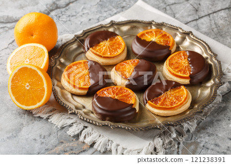 Sweet tasty cookies with candied orange and chocolate glaze close-up in a plate. Horizontal Sweet tasty cookies with candied orange and chocolate glaze close-up in a plate. Horizontal 121238391