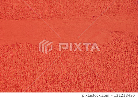 Rough red wall showing brushstrokes creating a textured background Rough red wall showing brushstrokes creating a textured background 121238450