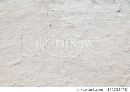 White painted concrete wall showing brushstrokes and cracks 121238458