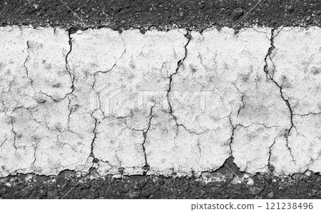 Cracked white line dividing asphalt road in black and white Cracked white line dividing asphalt road in black and white 121238496